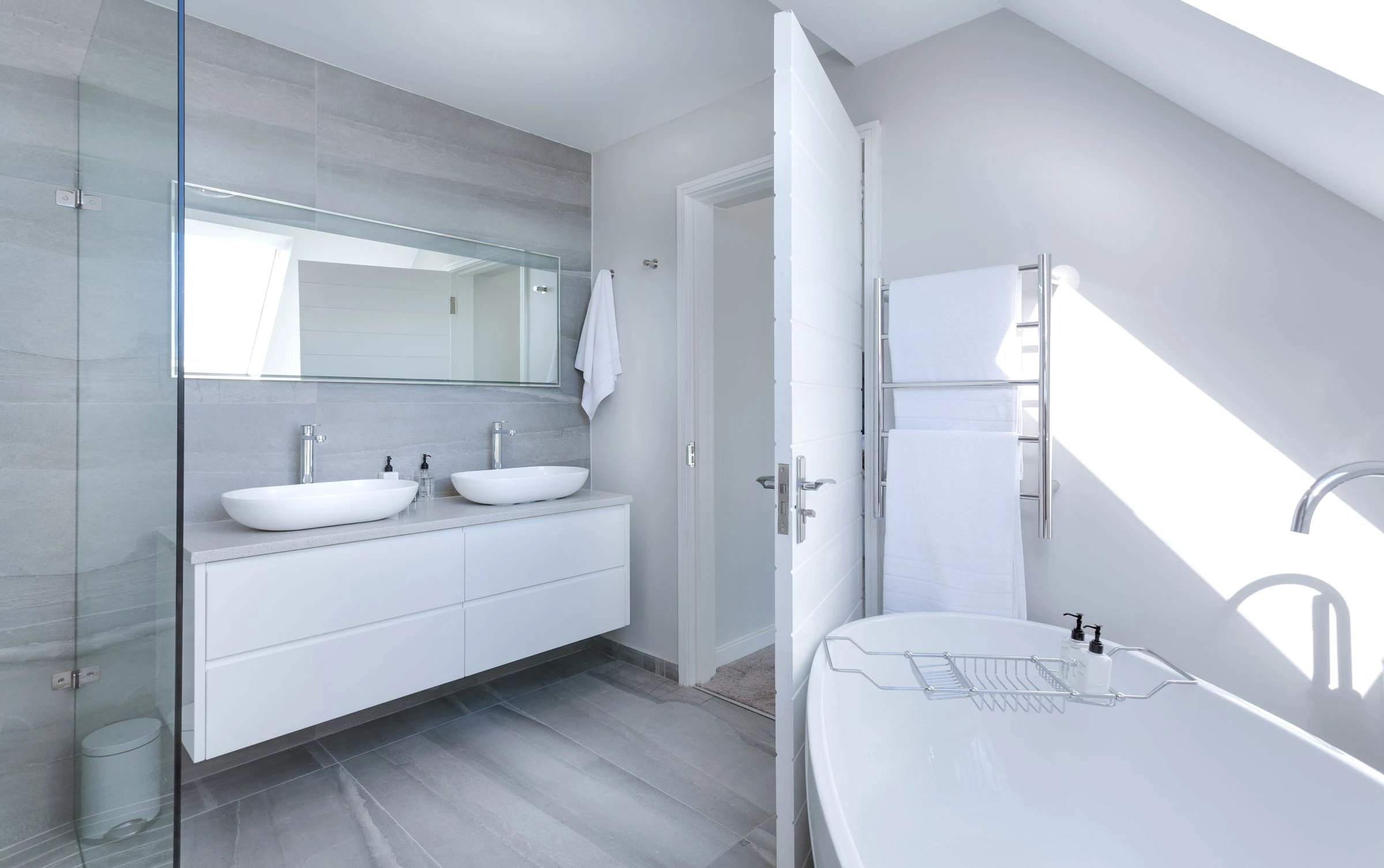 Bright modern bathroom with frameless glass shower partition